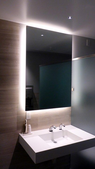 highlight the mirror in your bathroom with strip lighting to make your bathroom edgy and contemporary and add more light in the sink zone