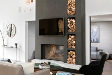 26 a contemporary living room with contrastign features – a tlall matte black wall with a fireplace and firewood storage plus a black chair