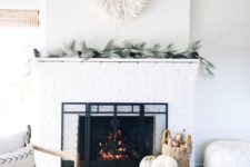 26 a cozy farmhouse living room done in white, with a white brick clad fireplace to add texture