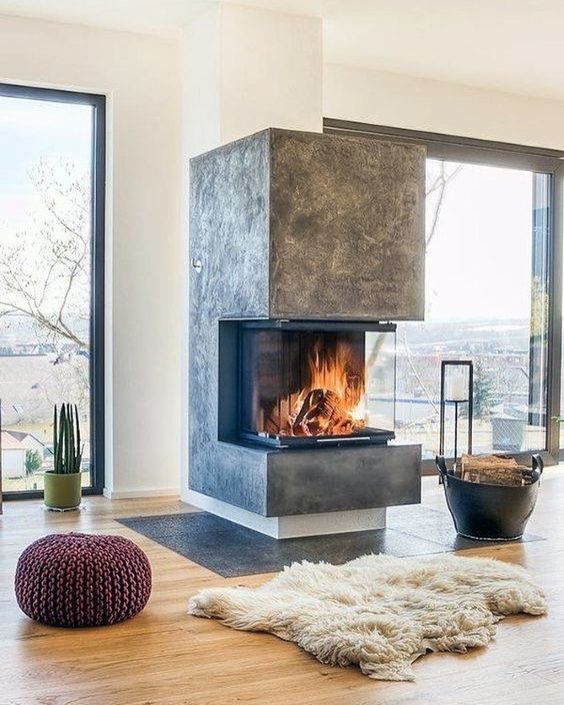 a modern fireplace like this one put in an open layout will make not one but two or more zones cozier