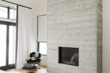 33 a built-in fireplace clad with weathered wood brings an inviting feel to the space and make it cozy