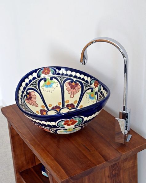 A colorful hand painted vessel sink is a beautiful idea for a Mexican inspired or just bright bathroom