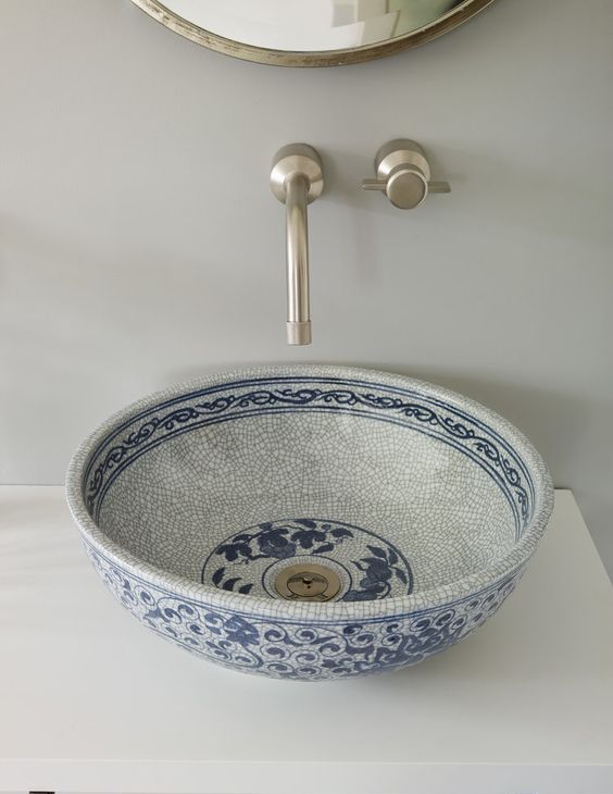 a gorgeous hand painted porcelain vessel sink in blues is a chic item to add a Moroccan feel