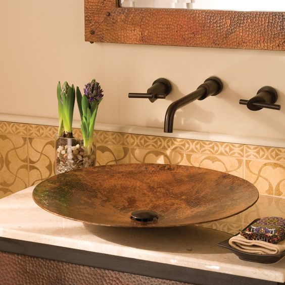 a sleek, contemporary copper vessel sink is wrought by master craftsmen using centuries-old techniques