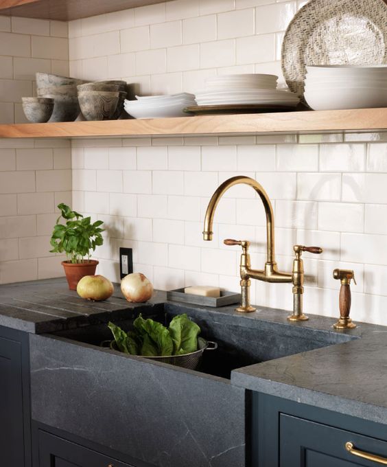 a soapstone undermount sink and a matching countertop for a chic moody farmhouse kitchen