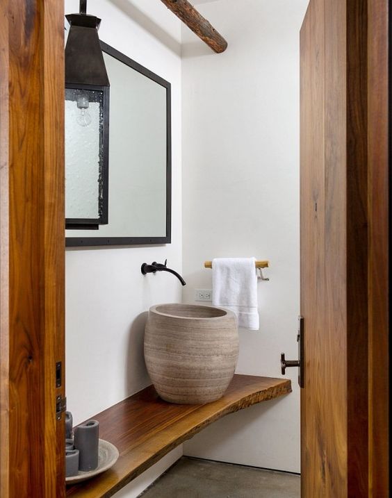A unique tall vase like vessel sink is ideal for a wabi sabi or spa inspired space