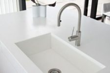 a white undermount sink in a white countertop create a perfect minimalist combo, which looks super laconic