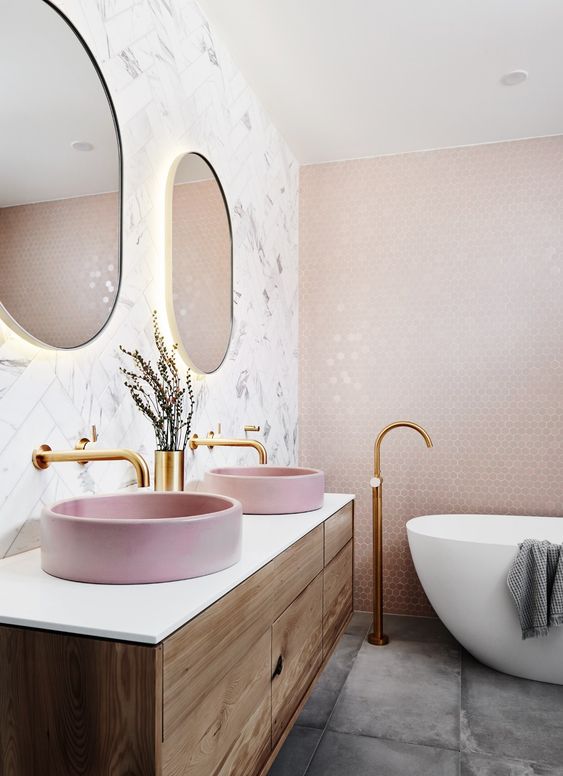 two round pink corian vessel sinks add color to the space and make it look more girlish