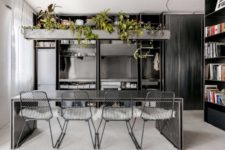 02 The kitchen is done with metal, all the appliances, a metal table and chairs plus a concrete planter over it