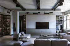 02 The living room features comfortable furniture, a minimalist coffee table and industrial lights on the ceiling