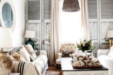 02 a beach cottage living room with wicker lamps over the space that add a cool coastal feel