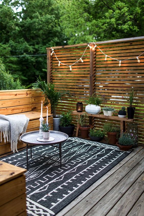 a boho patio with built-in and separate seating options and a coffee table as the center