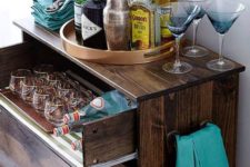 02 a dark stained IKEA Tarva dresser with a pullout drawer for stashing glasses and bottles is a chic rustic bar idea