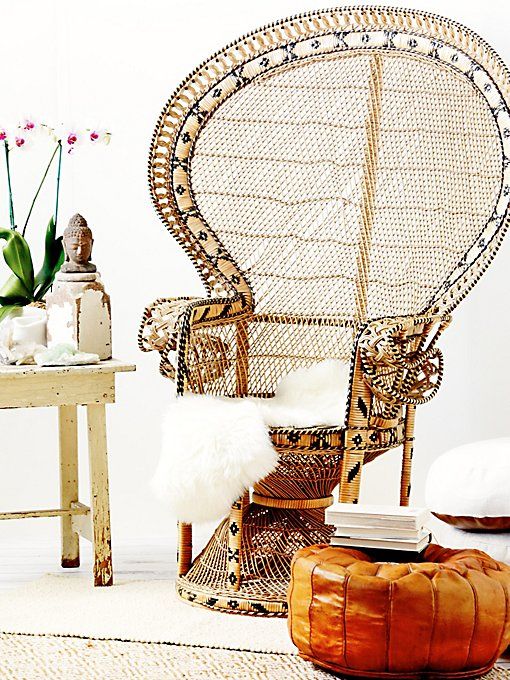 a peacock chair with yarn wrapping that adds a print to it, an amber leather ottoman and faux fur is impressive