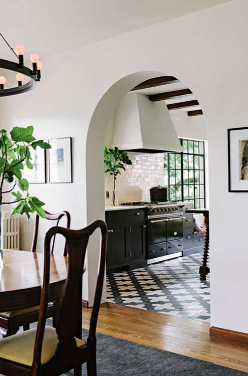an arched doorway leading to the kitchen hints on vintage style and touches of Spanish colonial decor you'll see