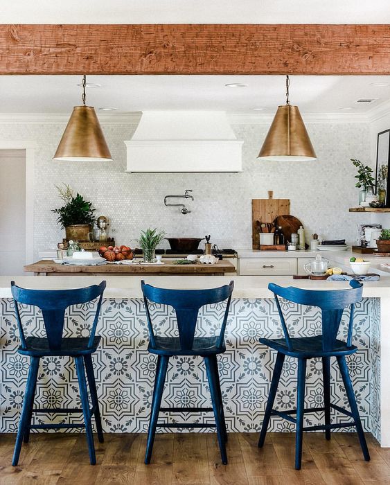tall navy stools with a vintage design match the tiled kitchen island and give a refiend feel to the space