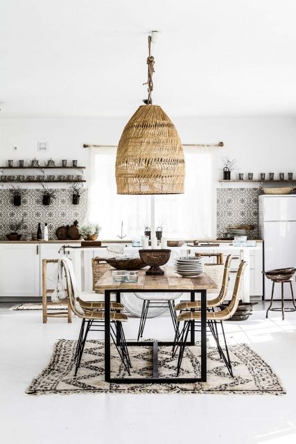 a boho eclectic kitchen and dining space with an oversized wicker lampshade over the dining zone and mosaic tiles