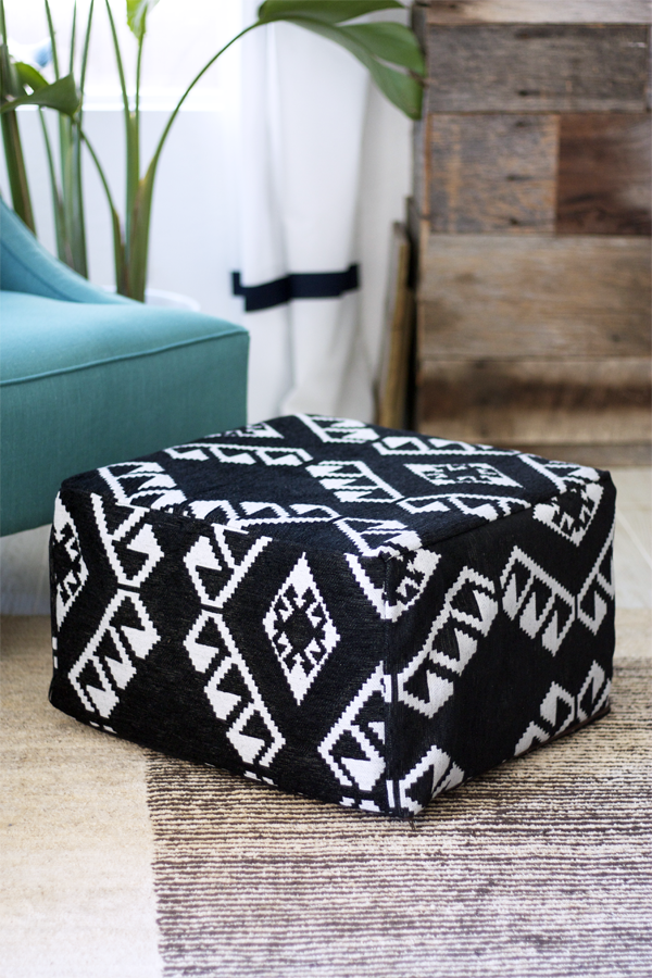 an IKEA footstool turned into a comfy boho folksy pouf in black and white with catchy patterns