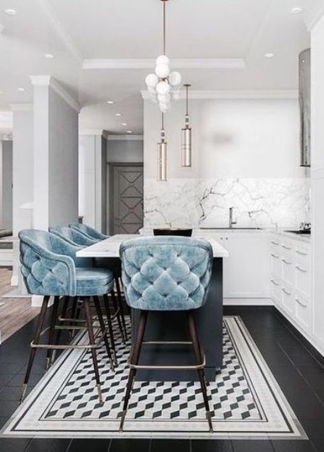soft baby blue tufted stools on dark stained legs add color to the space and look very inviting and chic