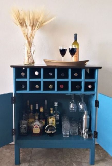 A bar cabinet in blue from a 3 drawer Tarva chest from IKEA using scraps of plywood and wood