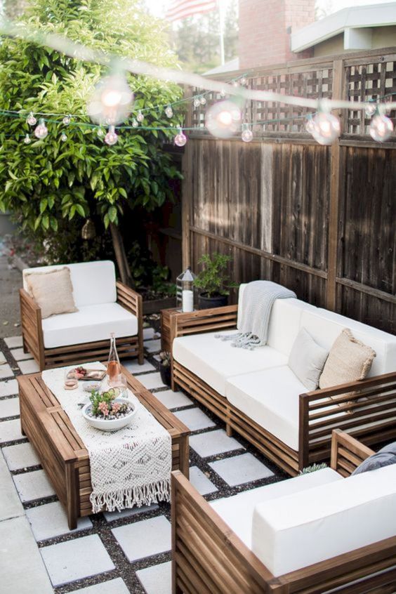 a welcoming patio with a seating group done around a single coffee table in the center