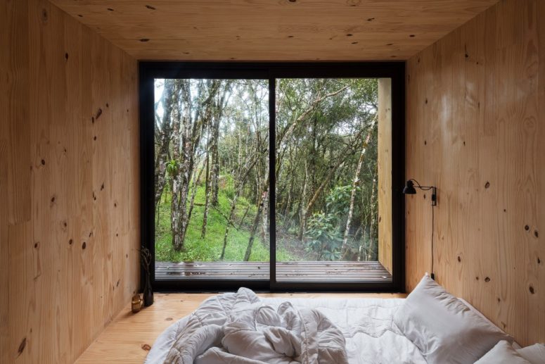 The bedroom features nothing but a comfy bed and a view - you won't need more to unite with nature