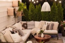 06 a boho patio with a large L-shaped sofa and a coffee table next to it plus wicker ottomans