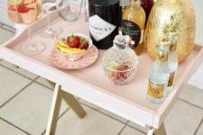 06 a genius IKEA hack to transform a tray table into an ultra-chic mini bar in blush is a very cute idea