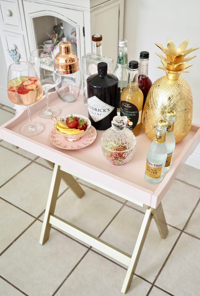 A genius IKEA hack to transform a tray table into an ultra chic mini bar in blush is a very cute idea