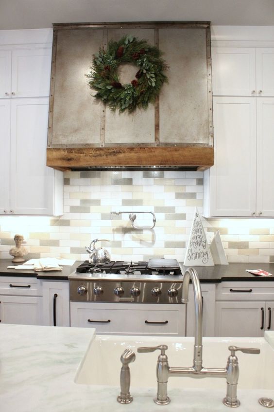 a modern farmhouse kitchen with white cabinets and a three tone skinny tile backsplash to add a touch of muted color
