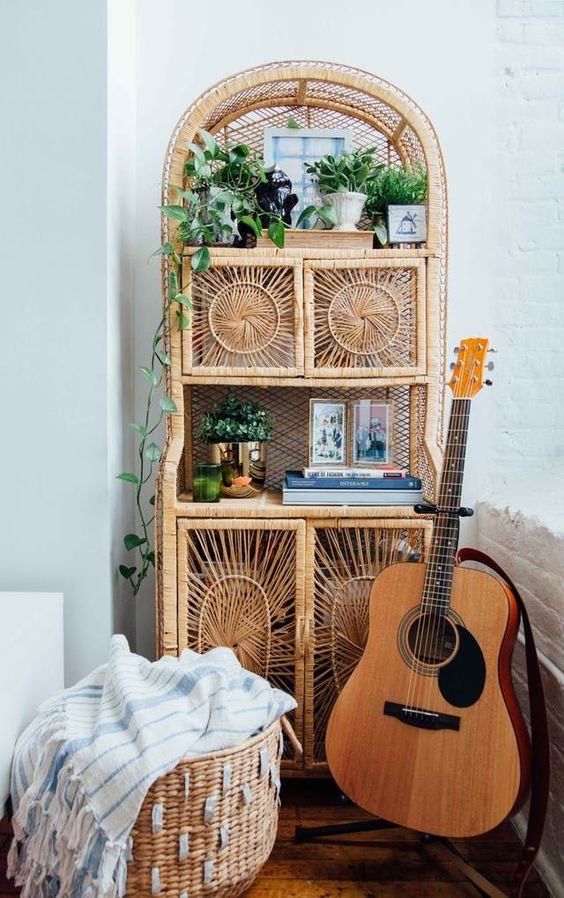 a rattan storage unit with potted greenery and other stuff is a great piece with a 70s feel