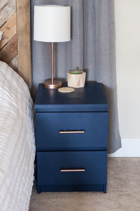 an old IKEA Malm nightstand hacked with navy paint and with metallic handles added for a chic new look