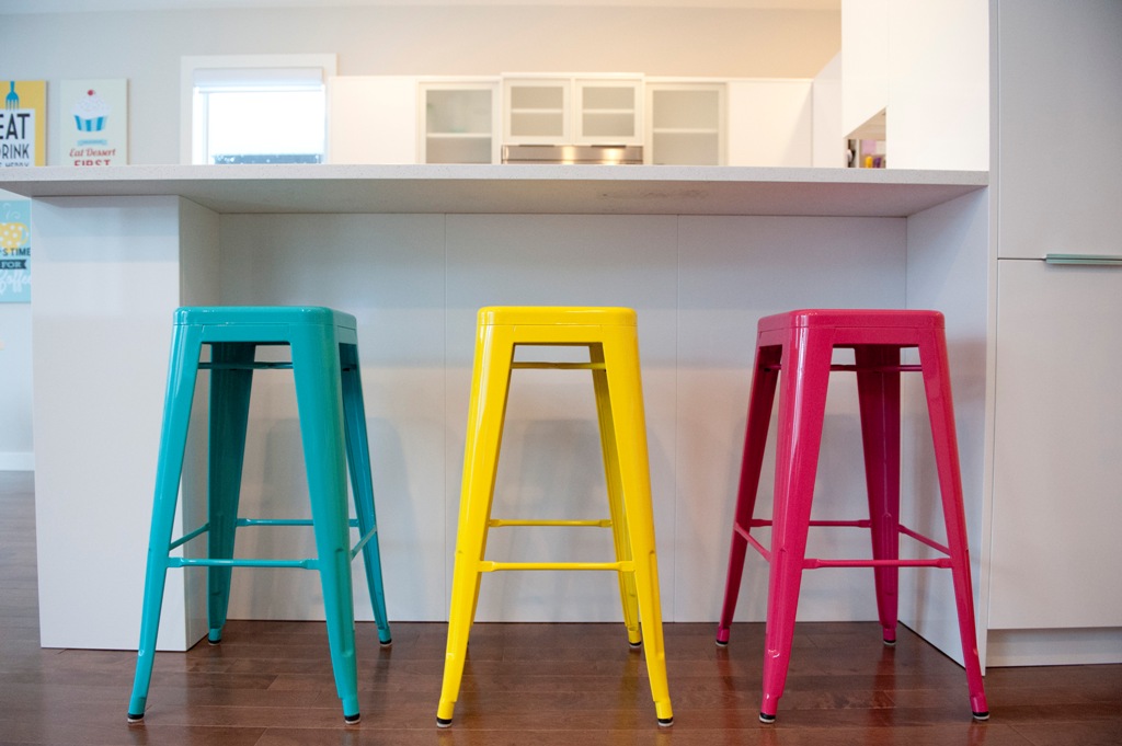 Modern colorful stools in multiple shades add brightness and a fun touch to the kitchen instantly
