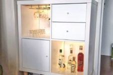 07 a small home bar with open and closed storage compartments with inner lights from an IKEA Kallax shelving unit