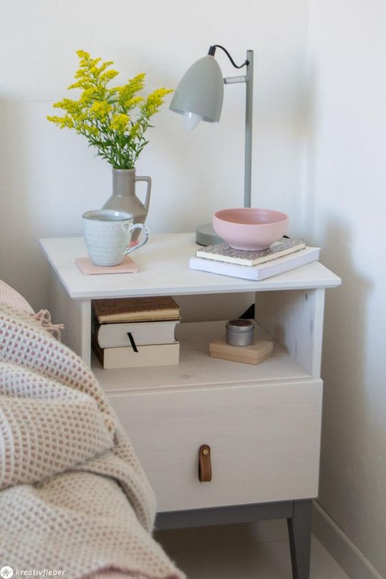 an IKEA Tarva nightstand painted white and grey, with a leather pull on the drawer for a mid-century modenr bedroom