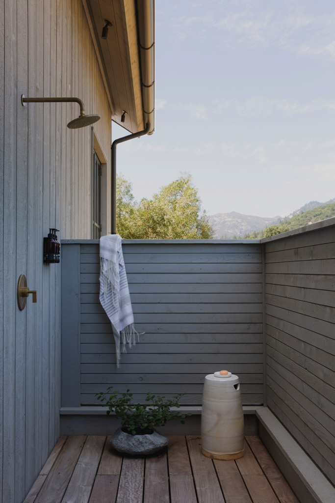 An outdoor shower is fully hidden for more privacy yet allows enjoying fresh air and showering outside
