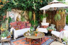 09 a colorful boho chic patio with a metal coffee table in the center and some seating furniture around it
