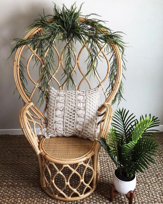a catchy rattan peacock chair refreshed with interwoven greenery is a stylish idea with a modern twist