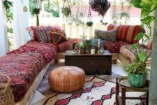 10 a colorful boho patio with a chest coffee table and all the seating furniture facing it to compose a group