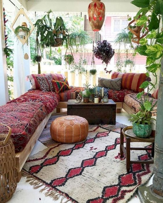 a colorful boho patio with a chest coffee table and all the seating furniture facing it to compose a group