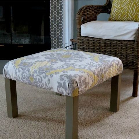 a living room ottoman made of an IKEA Lack table with printed grey and yellow fabric on top plus brown legs