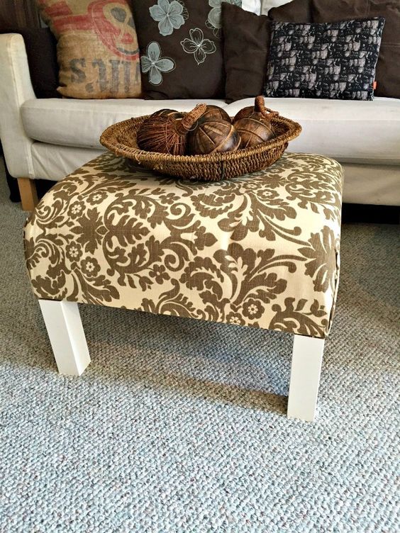 a plain and old IKEA Lack end table turned into a stylish ottoman with bright fabric on top