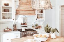 11 a vintage beach cottage kitchen with a wicker lampshade over the kitchen island for a more relaxed feel