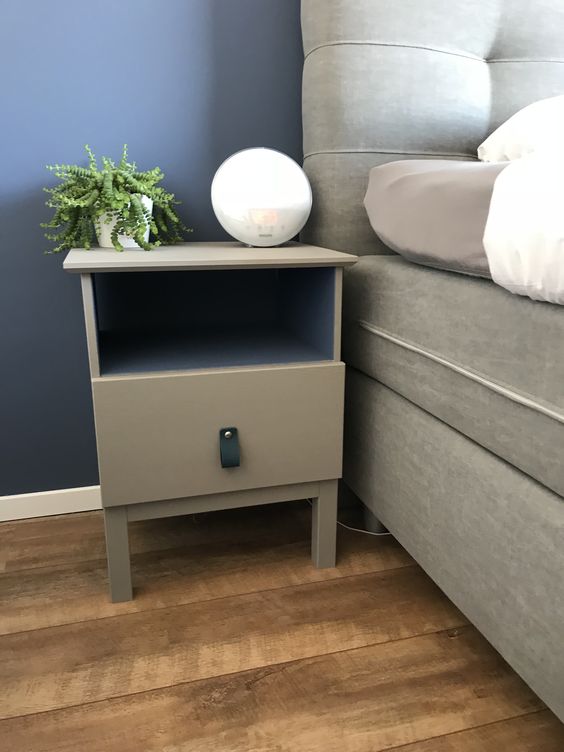 an IKEA Tarva nighstand painted grey and with a blakc leather pull is a simple makeover with plenty of style
