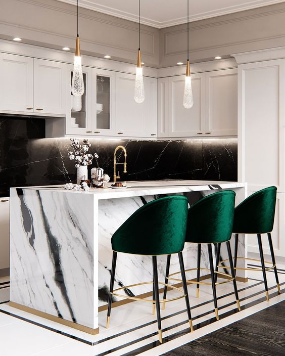 bold emerald stools with gold touches add color to the monochromatic kitchen and make the space cozier