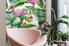 12 a cozy nook with pink flamingo print wallpaper, a blush chair, potted plants and a cork side table