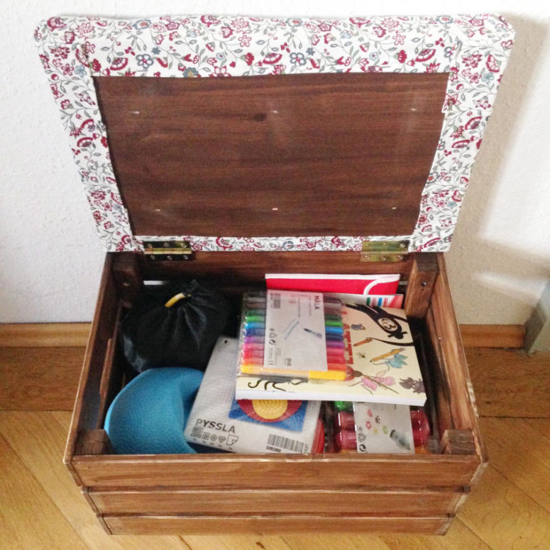 a simple and small ottoman of an IKEA Knagglig box with a top covered with bright floral fabric and storage inside