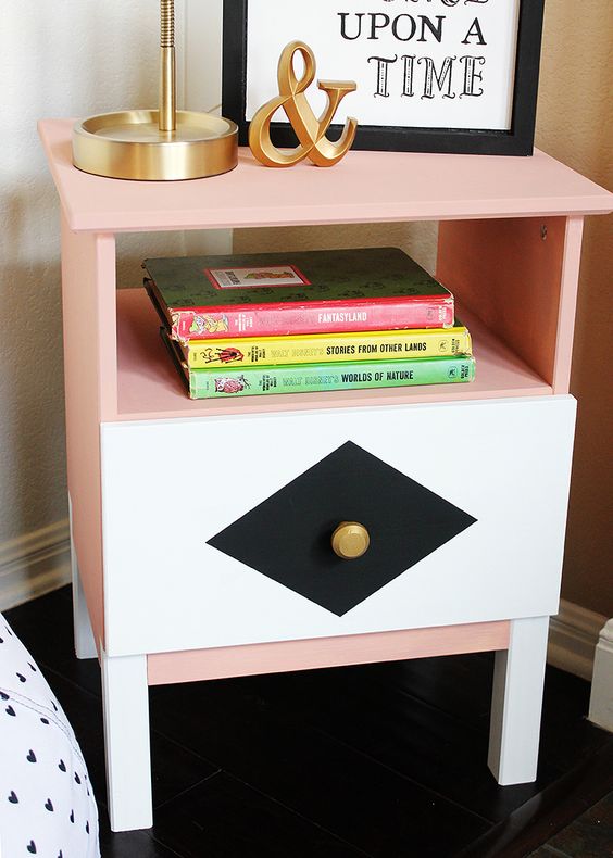 an IKEA Tarva nighstand in peachy pink, with geometric decor and a gilded knob is a bright idea