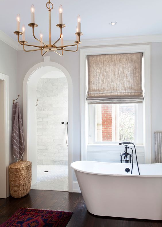 A contemporary bathroom with an arched doorway inviting to the shower space for more eye catchiness
