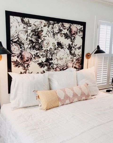 a headboard made of graphic floral wallpaper with a black frame is a very refreshing touch to the bedroom